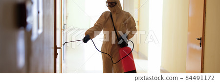 Virologist in protective hazmat suit disinfects surfaces in public and isolated areas Virologist in protective hazmat suit disinfects surfaces in public and isolated areas 84491172
