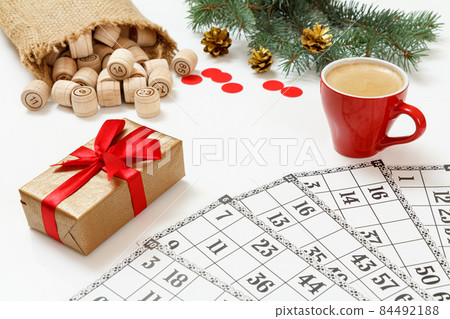 Wooden lotto barrels with bag, game cards and red chips for a game in lotto 84492188