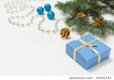 Natural fir tree branch with Christmas ornament on white background 84492343