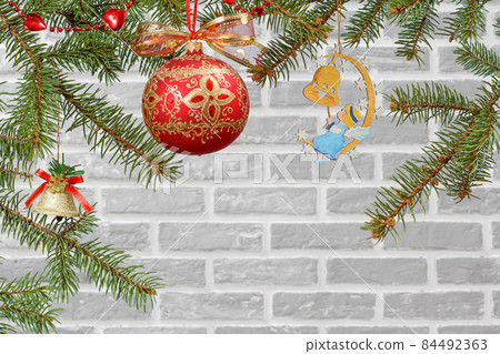 Branches of fir tree with Christmas toy ball and ornament 84492363