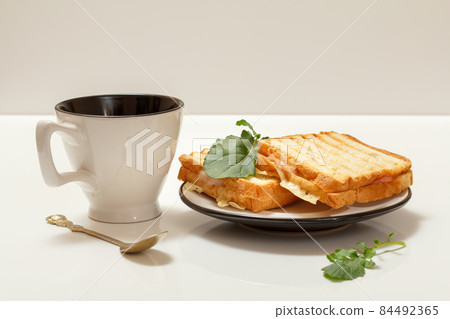 Homemade grilled cheese sandwiches for breakfast with cup of coffee. 84492365