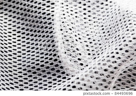 White lining in clothes in a hole, macro. Textured White lining in clothes in a hole, macro. Textured 84493696