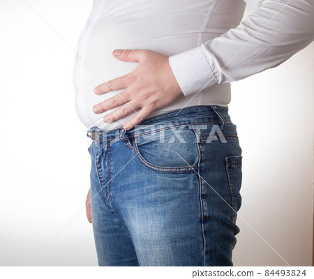 A fat man in a small, tight white shirt. Uncomfortable clothing concept, obesity. Slimming A fat man in a small, tight white shirt. Uncomfortable clothing concept, obesity. Slimming 84493824