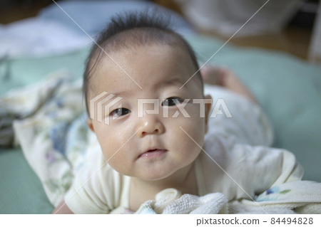 Baby roaming on a futon Baby roaming on a futon 84494828
