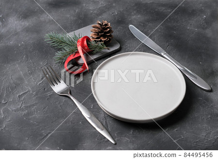 empty plate with tableware and christmas decor on grey table. copy space. table setting template for new year or christmas menu. restaurant menu mock up. top view empty plate with tableware and christmas decor on grey table. copy space. table setting template for new year or christmas menu. restaurant menu mock up. top view 84495456
