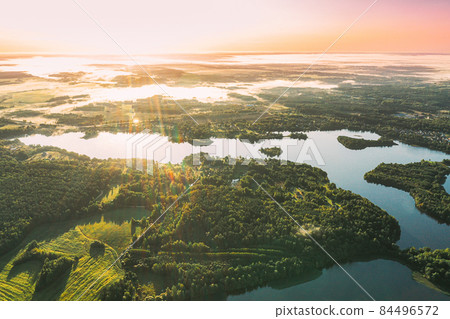 Lyepyel District, Vitebsk Region, Belarus. Aerial View Of Sunset Sunrise Above Residential Area With Houses In Countryside. Morning Fog Above Lepel Lake. Bird's Eye View Of Lepel Lake 84496572