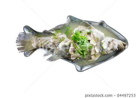 Top view of Steamed Seabass with Lime and Chillies in fish shape plate. 84497253
