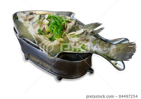 Top view of Steamed Seabass with Lime and Chillies in fish shape plate. 84497254