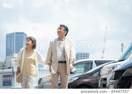 Senior couple blue sky parking lot 84497347