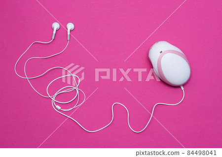 Fetal doppler with headphones for listening to the baby's heartbeat in pregnant women, close-up, pink background, instrument Fetal doppler with headphones for listening to the baby's heartbeat in pregnant women, close-up, pink background, instrument 84498041