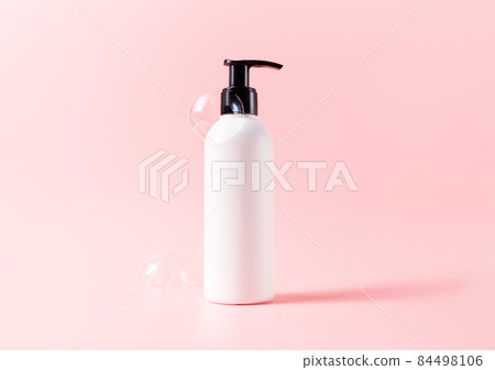 Bottle with soapy bubbles. Beauty skincare cosmetic packaging mockup 84498106