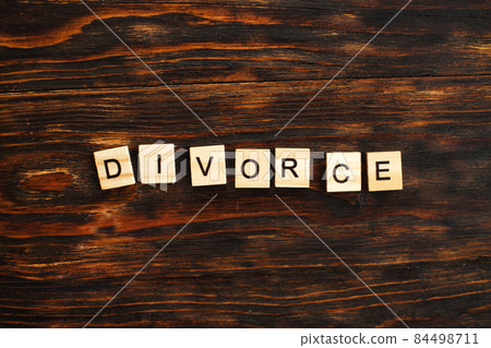 inscription divorce made by wooden blocks on wooden background. broken family concept inscription divorce made by wooden blocks on wooden background. broken family concept 84498711