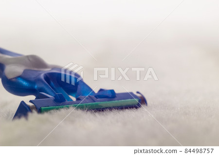 Men's beard shaver on white fleecy material, macro, male shave, copy space, pile Men's beard shaver on white fleecy material, macro, male shave, copy space, pile 84498757