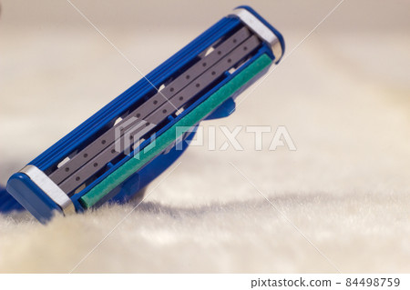 Men's beard shaver on white fleecy material, macro, male shave, copy space Men's beard shaver on white fleecy material, macro, male shave, copy space 84498759