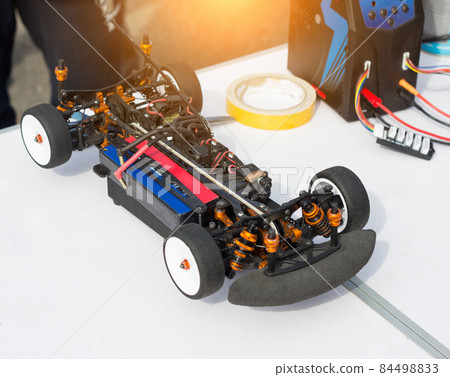 Preparation of an electric radio-controlled car before the start of a car sport competition, close-up, auto Preparation of an electric radio-controlled car before the start of a car sport competition, close-up, auto 84498833