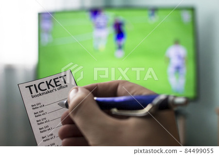 Men's hands with a ticket bookmaker's office, on TV show football, Champions League, sports betting, close-ups 84499055