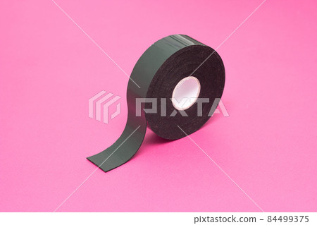 Reel of double-sided tape on a pink background, close-up, double-sided adhesive tape, element 84499375