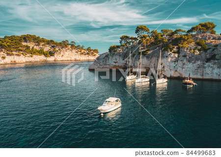 Cote de Azur, France. White Yachts boats in bay. Calanques - a deep bay surrounded by high cliffs in the azure coast of France 84499683