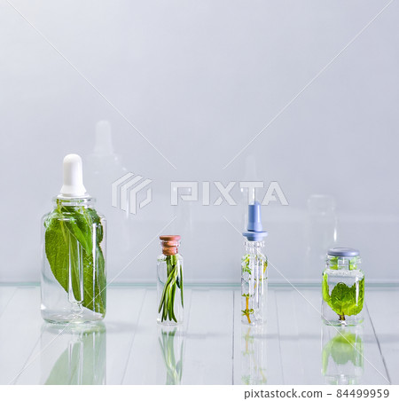 Countertop with bottles with herbal preparations in a clear liquid. Countertop with bottles with herbal preparations in a clear liquid. 84499959