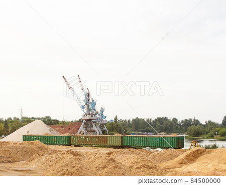 The port crane makes loading of wood chips into the freight cars of the train, loading 84500000