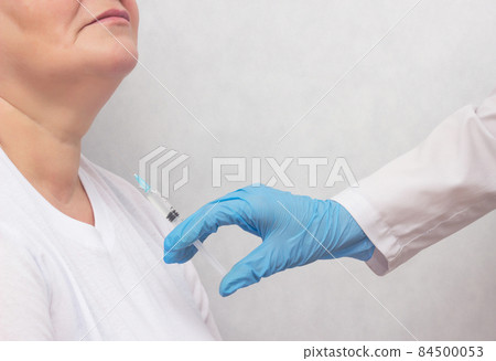 The doctor makes the woman puncture the thyroid gland to clarify the diagnosis, cancer, copy space The doctor makes the woman puncture the thyroid gland to clarify the diagnosis, cancer, copy space 84500053