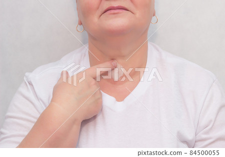Woman rubs therapeutic cream-gel for the thyroid gland, treatment of the thyroid gland, close-up, medicinal Woman rubs therapeutic cream-gel for the thyroid gland, treatment of the thyroid gland, close-up, medicinal 84500055