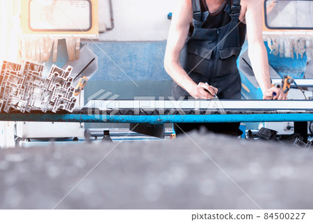 Production of PVC windows, the worker records dimensions on the profile of the frame pvc, felt pen arm 84500227