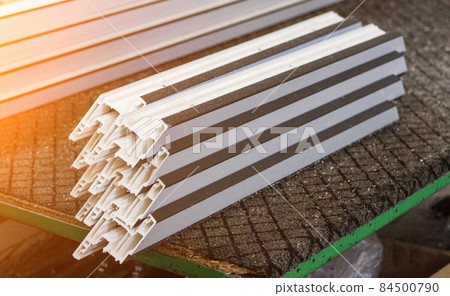 Production of pvc windows, plastic pvc profile lies on the table, close-up, section Production of pvc windows, plastic pvc profile lies on the table, close-up, section 84500790