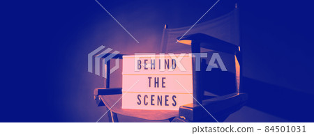 Director chair with behind the scene banner light box. Letterboard text Lightbox or Cinema Light box. Movie clapperboard and Director chair. Black Background. Represent video behind the scenes is on. Director chair with behind the scene banner light box. Letterboard text Lightbox or Cinema Light box. Movie clapperboard and Director chair. Black Background. Represent video behind the scenes is on. 84501031