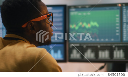 Black trader analyzing financial data 84501500
