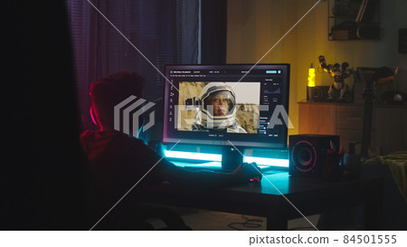 Teenager retouching photo at night Teenager retouching photo at night 84501555