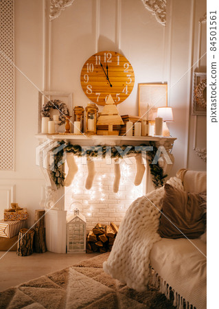 New Year's atmosphere. an armchair by the fireplace decorated for the New Year. New Year's atmosphere. an armchair by the fireplace decorated for the New Year. 84501561
