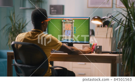 Black man playing videogame on computer Black man playing videogame on computer 84501563