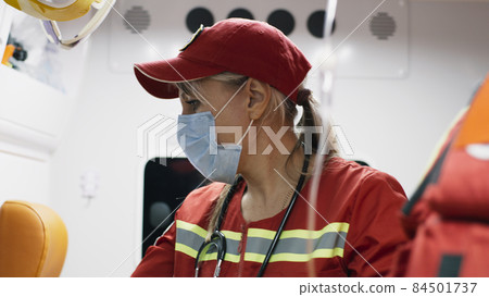 Paramedics talking during patient rehabilitation 84501737