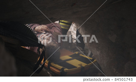 Teenager being saved from debris 84501743