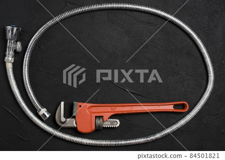wrench flexible connector dark table. High quality photo wrench flexible connector dark table. High quality photo 84501821
