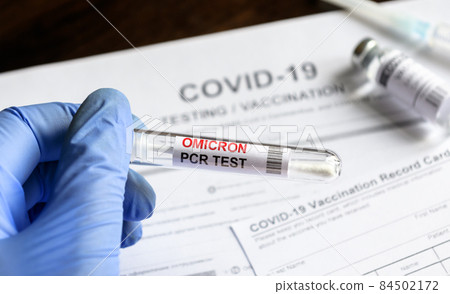 Omicron COVID-19 PCR test in doctor hand 84502172