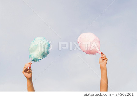 hands holding cotton candy. High quality photo hands holding cotton candy. High quality photo 84502201