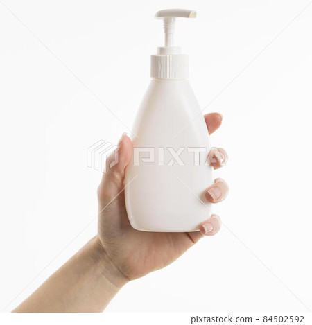 hand holding liquid soap bottle. High quality photo hand holding liquid soap bottle. High quality photo 84502592