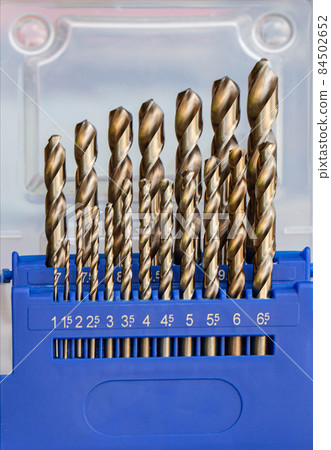 A set of new drills for metal for drilling a hole. Metal tools, industry. Close-up A set of new drills for metal for drilling a hole. Metal tools, industry. Close-up 84502652