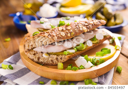 Dutch herring. Toast with Dutch herring, onions, pickles. Traditional rustic appetizer with seafood Dutch herring. Toast with Dutch herring, onions, pickles. Traditional rustic appetizer with seafood 84503497