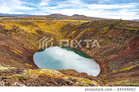 Volcanic crater Kerid with blue lake inside, Iceland tourist attraction Volcanic crater Kerid with blue lake inside, Iceland tourist attraction 84504002