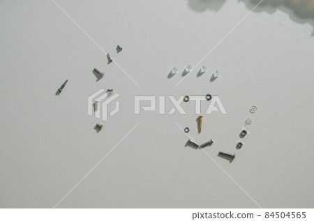 Bolts for repairing eyeglass frames on a white background. Bolts for repairing eyeglass frames on a white background. 84504565