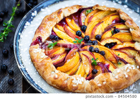 Rustic open pie (galette) with peach and berry Rustic open pie (galette) with peach and berry 84504580