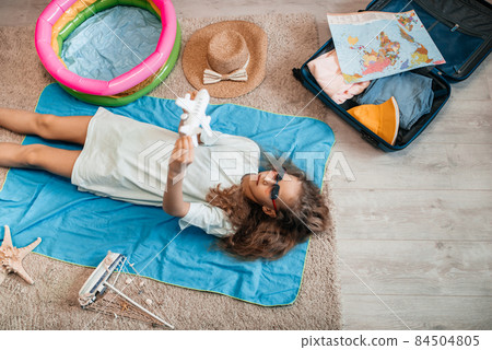 woman tuck at quarantine at home dreaming about sea beach vacation. 84504805