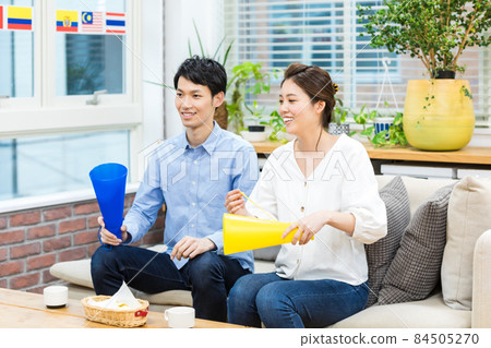 A couple watching sports on TV 84505270