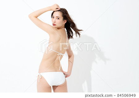 Portrait of a woman in a white bikini Portrait of a woman in a white bikini 84506949