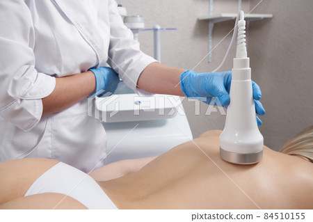 Hardware cosmetology. Young woman getting beauty treatment in spa salon 84510155