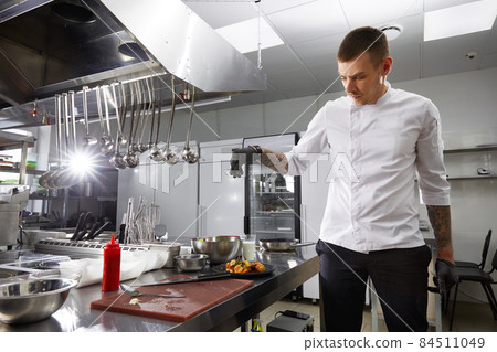 Professional chef cooking in the modern kitchen in hotel restaurant, preparing shrimp salad Professional chef cooking in the modern kitchen in hotel restaurant, preparing shrimp salad 84511049