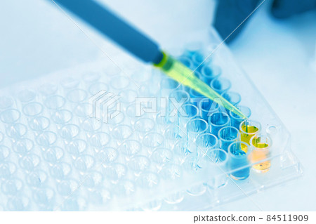 Lab Worker Adding Liquid to Test Tubes 84511909